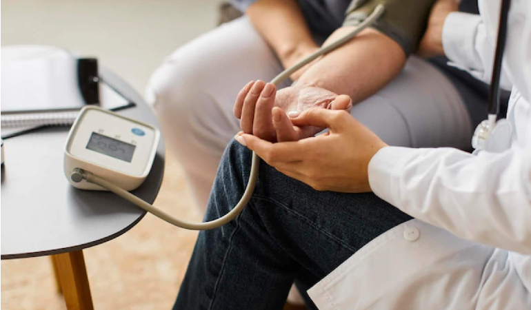 A skilled nurse checking a patient's vitals at a 24x7 nurse station, highlighting continuous supervision in a Senior care facility with round the clock healthcare in India.