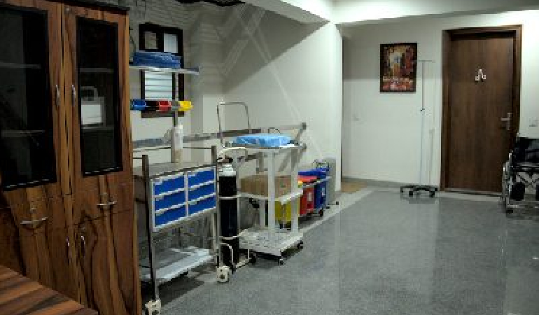 A senior resident utilizing a mobility aid in a rehabilitation area, highlighting the in-house Physiotherapy at Old age home with Post operative care in India.