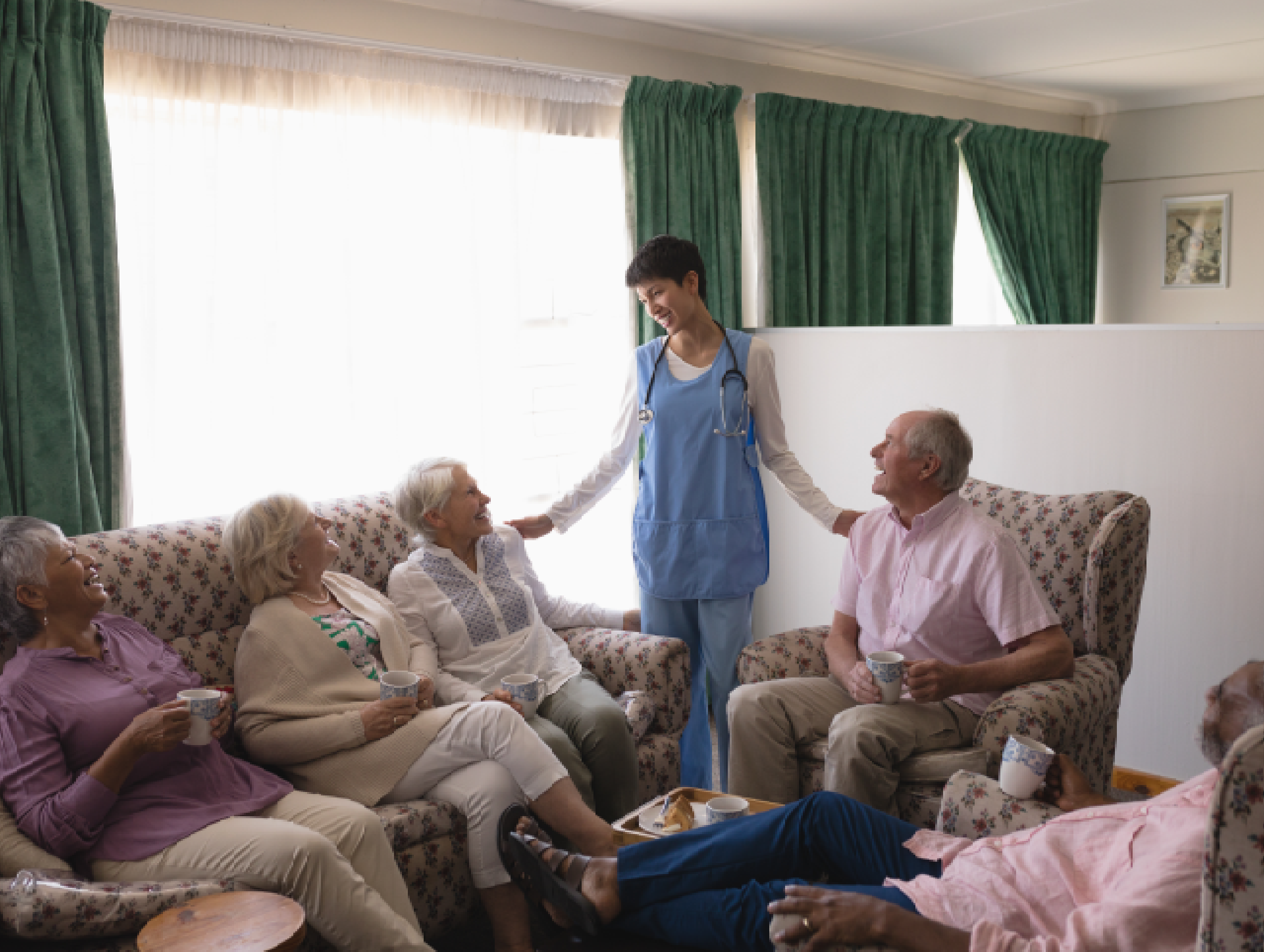 An image showing a spacious and elegantly decorated common lounge area where senior residents are socializing