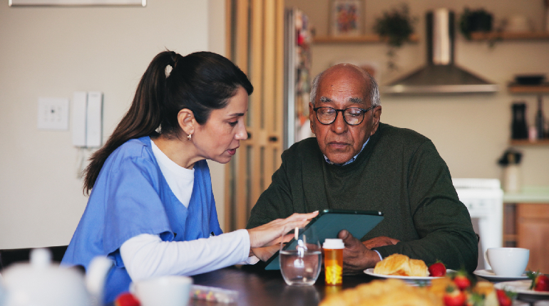 A specialized dietitian discussing a low-glycemic meal plan with a resident at a diabetes-focused senior living in India
