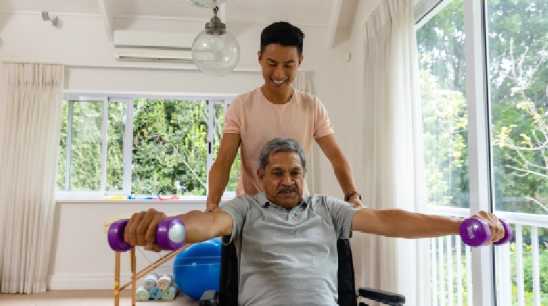 A senior resident performing guided gait training with a therapist at a stroke rehabilitation senior living in India