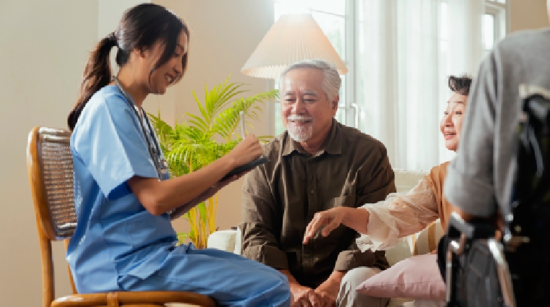 A specialized palliative nurse providing comfort care and companionship to an elder at a senior care facility with round the clock healthcare in India