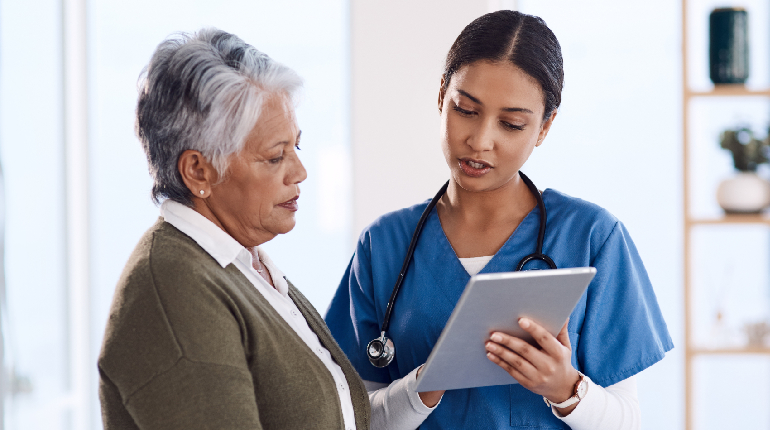 A senior and a nurse discussing a personalized health plan at Artha