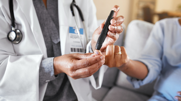A nurse conducting regular health checks for a resident with diabetes
