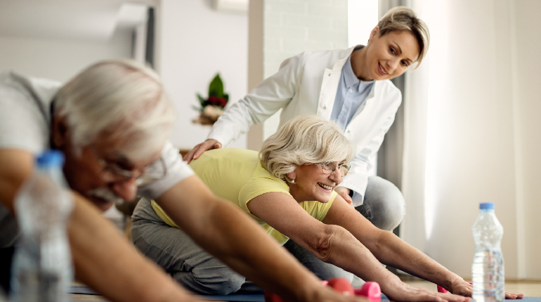 A senior resident practicing rhythmic gait exercises with a specialized neuro-physiotherapist at an old age home for 24x7 healthcare in India