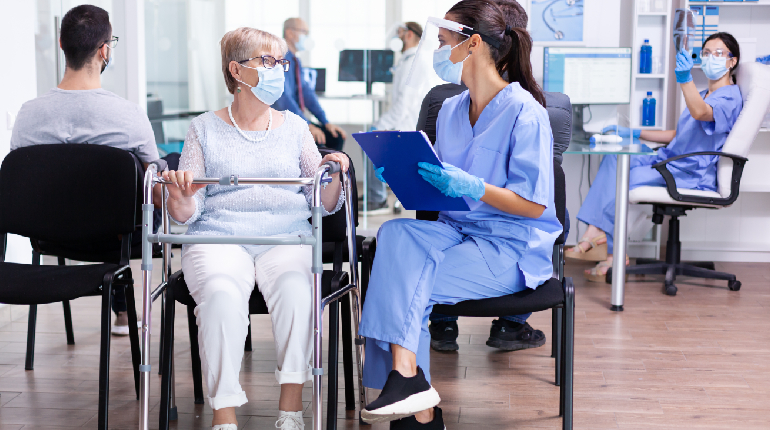 A team of skilled caregivers & nurses managing clinical protocols at a nurse station.
