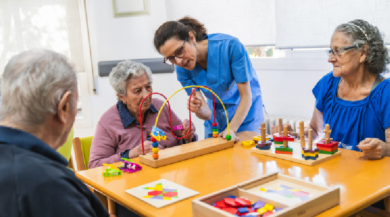 An elderly resident participating in a tactile art therapy session at Artha