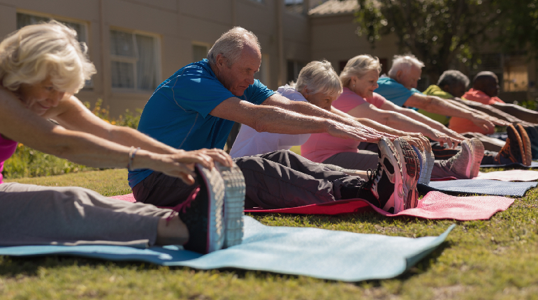 Seniors participating in a gentle stretching group at a senior day care centre